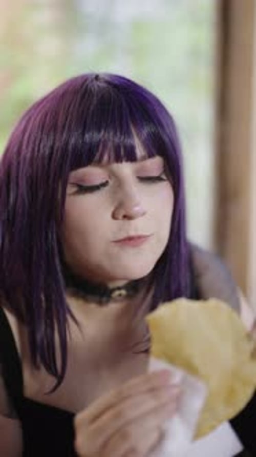 Woman With Purple Hair Eats Savory Pie Snack