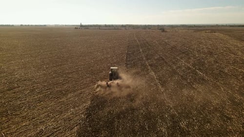 Slow Motion Drone View of Tractor Plowing Farm Field