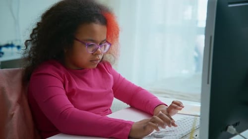 Young Student Typing on Keyboard at Home