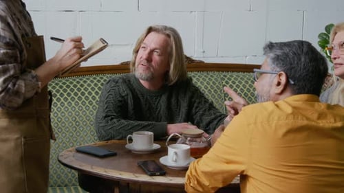 Group of Old Friends Ordering Desserts with Tea from Waitress in Restaurant