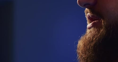 Closeup of a European Podcast Blogger Smiling While Broadcasting His Live Audio Podcast in a Studio