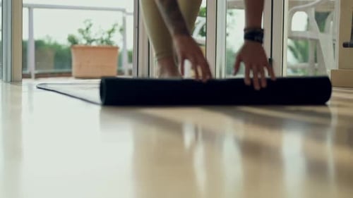 Training, yoga mat and and person hands getting ready in home or studio for holistic wellness