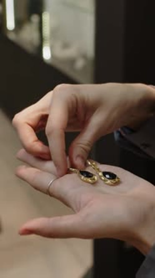 Hands of Two Multiethnic Women Choosing Earrings in Jewellery Store