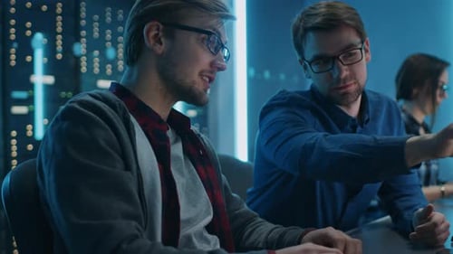 Engineers work in futuristic office late at night