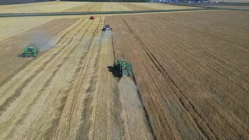 Different Agriculture Machines Harvesting Grain in Wheat Field Drone Point of View.