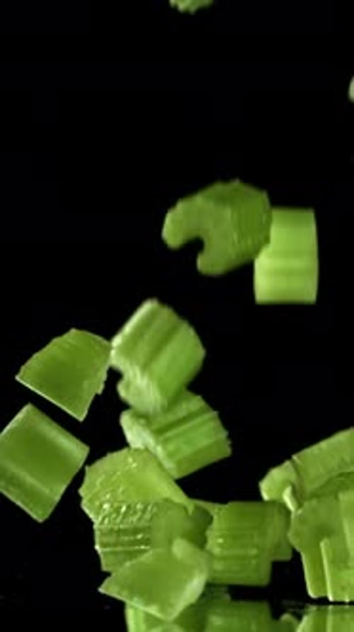 Sliced Pieces of Fresh Celery Fall on the Table Filmed on a Highspeed Camera at 1000 Fps