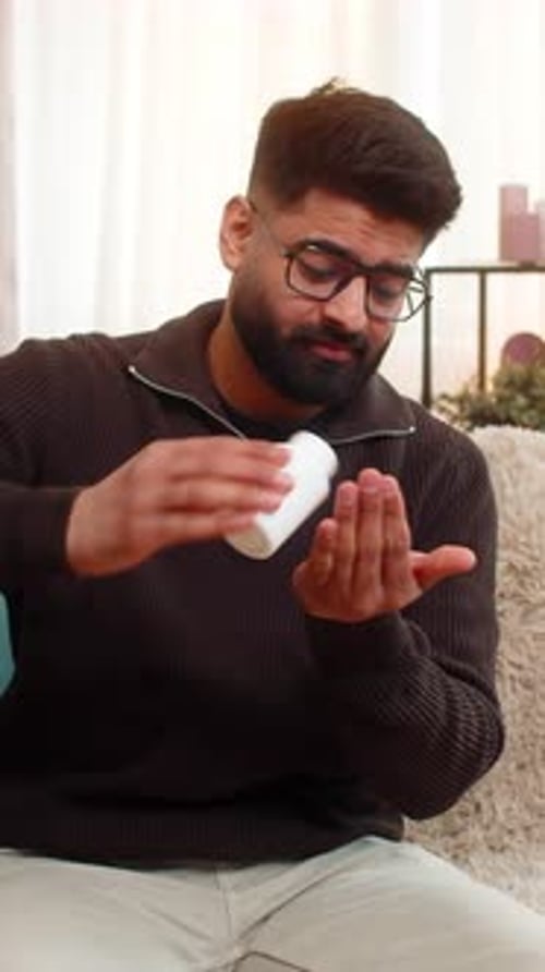 Man with Stomach Ache Takes Medicine at Home