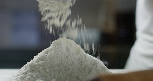 Flour Being Poured onto a Mound of Flour