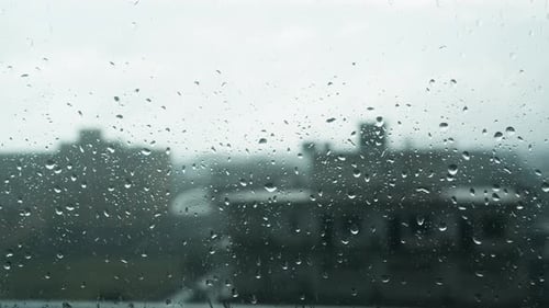 Rainy Day In The Blurred City Over Window