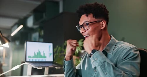 Young Adult Celebrating Success in Office