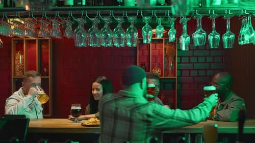 Bartender Serving Customers at Bar Counter with Pints of Beer
