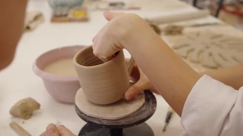 Crafting a Clay Mug at a Local Pottery Studio in the Afternoon