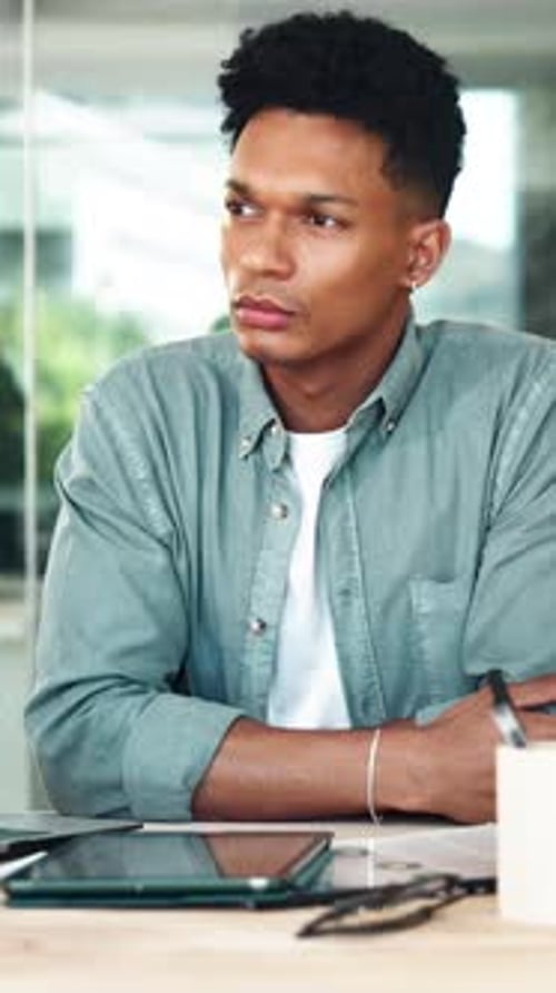 Thinking, laptop and creative man in startup for inspiration, research project or perspective