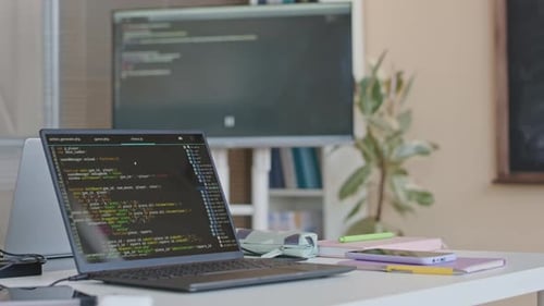 Laptop displaying Code in a modern office