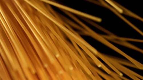 Close Up of Raw Spaghetti Noodles Against Black