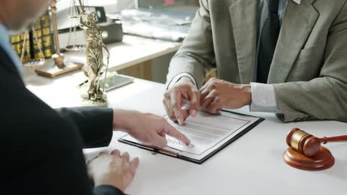 Lawyers Discussing Contract Agreement in Office Setting