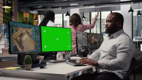 Green Screen and Architectural Software on Dual Monitors in Creative Agency