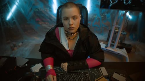 Stylish woman sitting at computer in futuristic setting