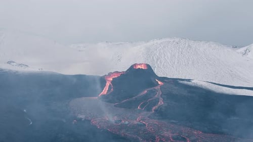 Active Geldingadalsgos volcano in winter landscape of Iceland with snowy hill