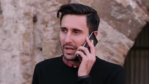 Young Man Chatting on Phone in Urban Setting