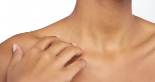 Woman Gently Scratching Bare Neck and Shoulder