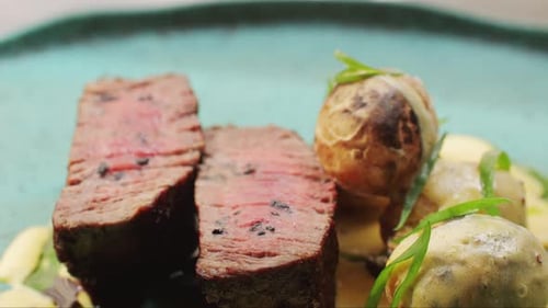 Juicy Medium Beef Meat Rib Eye Steak Slices with Baked Potato in Expensive Modern Fusion Restaurant