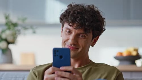 Man Using Smartphone Indoors At Home