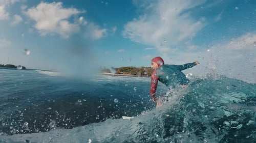 Surfer Rides the Ocean Wave in the Maldives In Water and Underwater View of the Surfer on the Wave