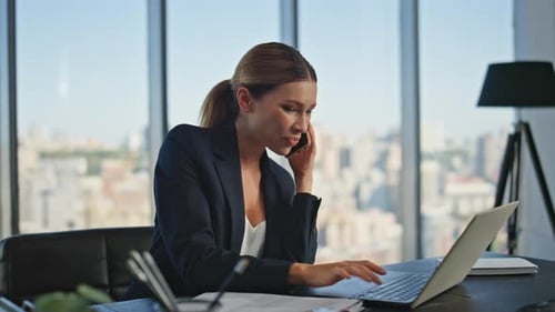 Smiling Executive Speak Mobile Phone in Panoramic Office Manager Using Laptop