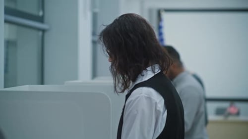 Dolly Shot of Diverse American Citizens Voting in Booths