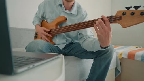 Man Plays Bass Guitar at Home