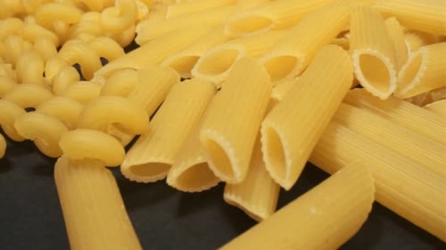 Uncooked Penne and Rotini Pasta Close Up