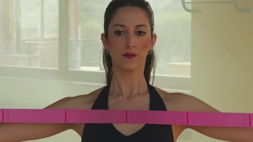 Woman Exercising Arms with Resistance Band Indoors