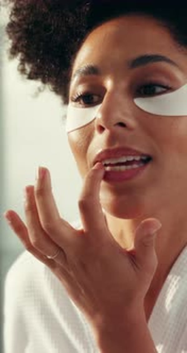 Beauty, eye mask and face of woman in bathroom of home for cosmetic or ...