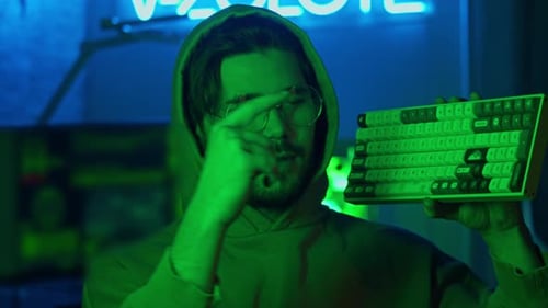 Portrait of a Programmer Looks Directly Into the Camera Illuminated By Neon Lights The Programmer