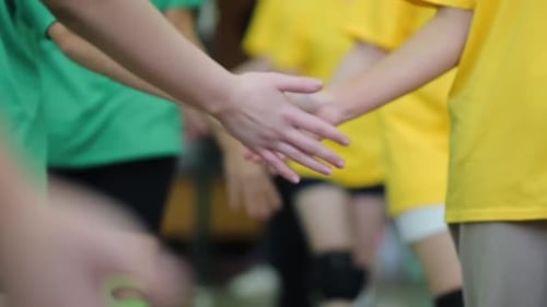 Young Athletes Joining Hands in Team Building Exercise