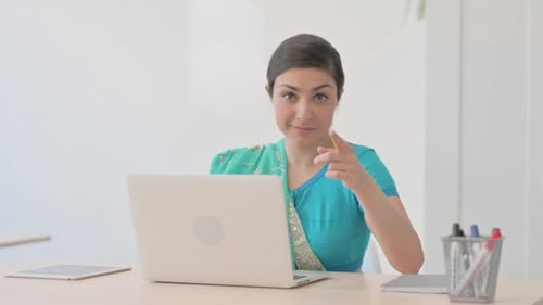 Indian Woman in Sari Pointing at Camera while Working on Laptop