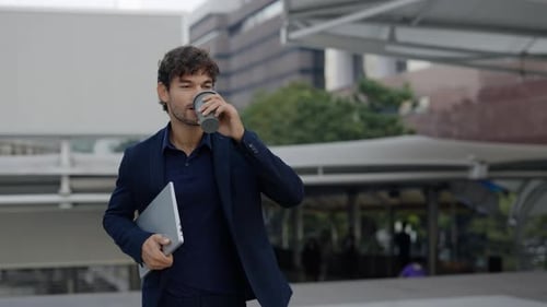 Portrait of Hispanic Office Employee with Tablet and Coffee Walks Along Street