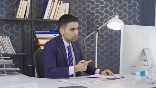 Businessman having video meeting in office.