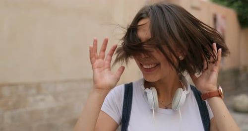 A Pretty Girl is Shaking Her Head and Laughing