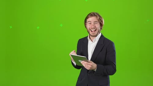 Excited Man Celebrating with Tablet on Green Screen
