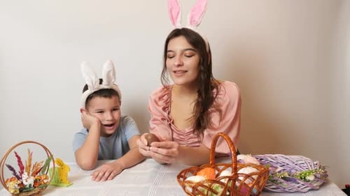 21. Mother, son and daughter are treated to an Easter chocolate egg. Celebrating Easter in the famil