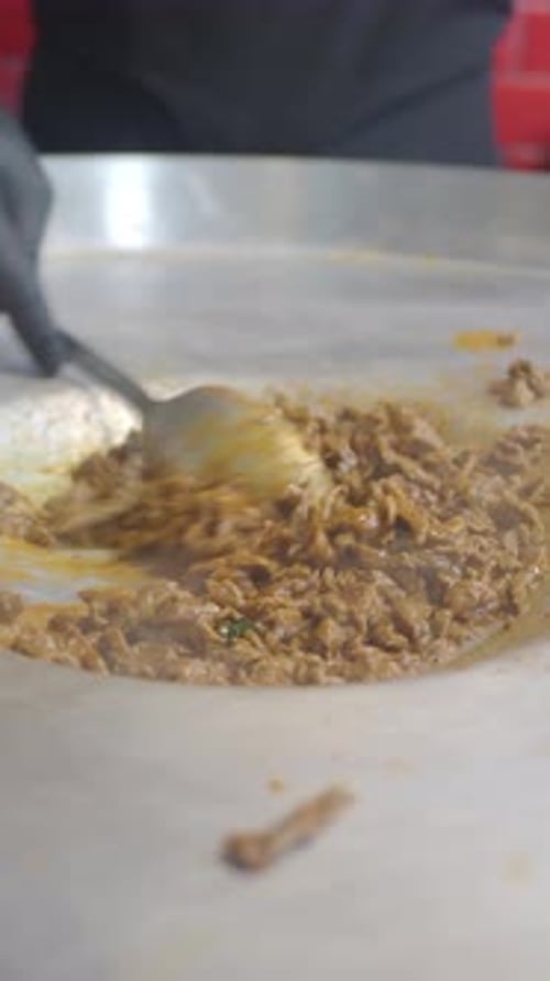 Cooking Savory Beef in a Bustling Kitchen Environment