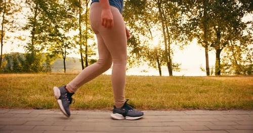 Closeup of Young Sporty Woman Runner Legs Training in Morning in Public Park Fitness Girl is Jogging