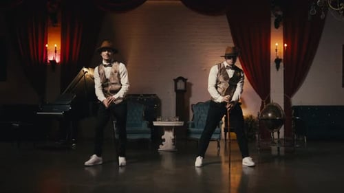 Two Young Adults Dance with Canes Indoors