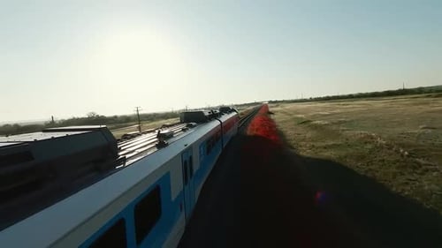 Train Travels Through Countryside on Sunny Day