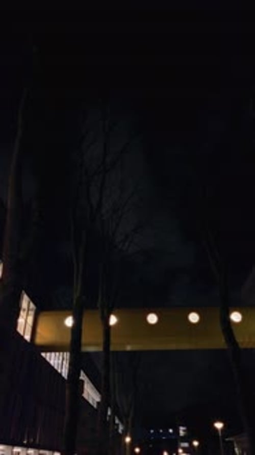 Elevated Walkway with Circular Lights at Night at t Hoogt Amsterdam Noord