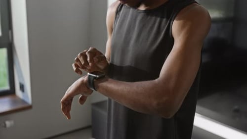 Man Turning on Timer on Fitness Watch and Running on Spot during Home Workout