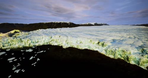Drone Captures Shoreline Erosion and Melting Ice at Dusk Coast