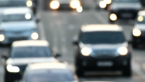 Heavy traffic on the highway at dusk in a crowded urban megalopolis